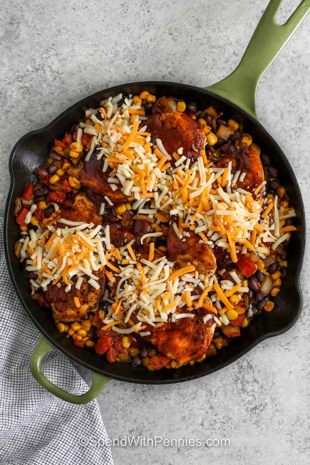 adding chicken sauce and cheese to pan to make Cowboy Chicken