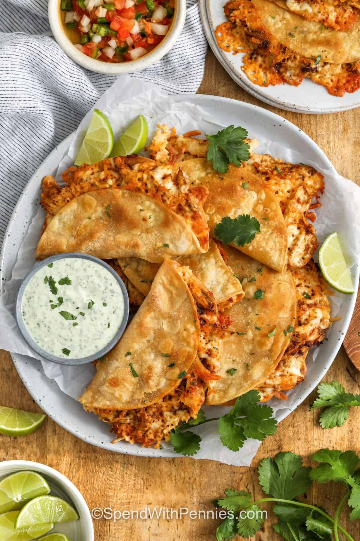 top view of cheesy Crispy Chicken Tacos on plate