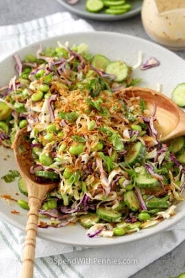 Close up of Crispy Rice Salad tossed together with salad tongs.