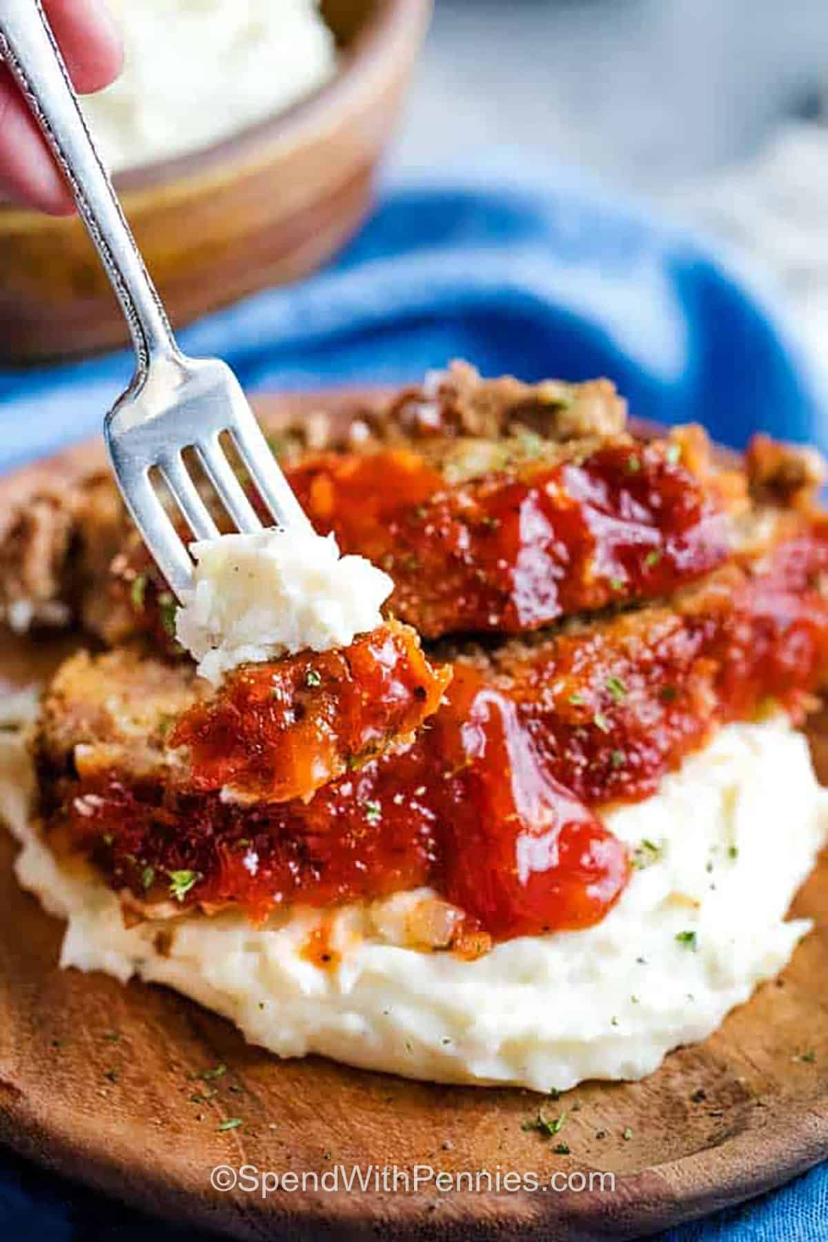 taking a fork full of Crockpot Meatloaf with mashed potatoes