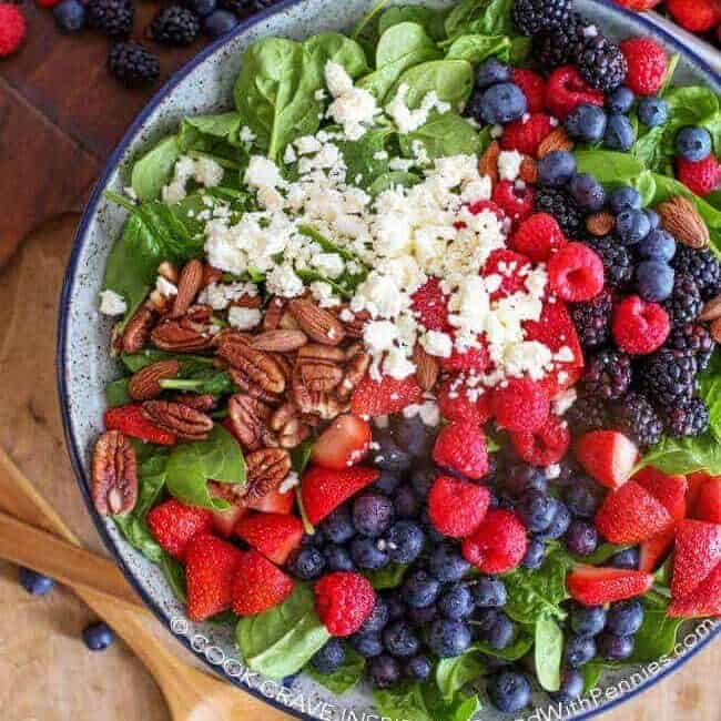 Overhead shot of Fruit & Nut Spinach Salad on a cutting board
