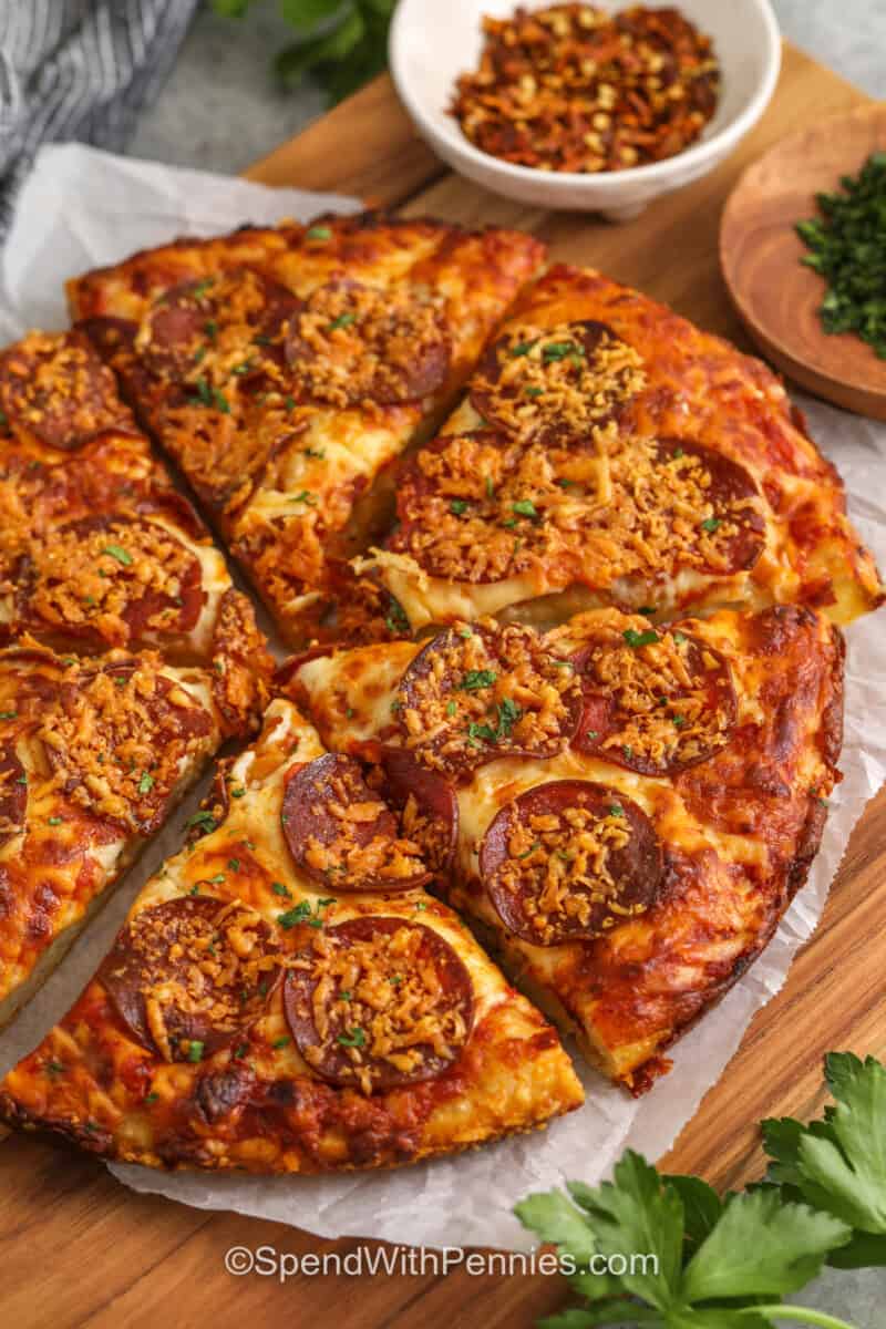 Homemade pan pizza is one of the easiest ways to make pizza night feel special without extra work. The dough rests right in the oiled skillet, which helps create a crisp bottom and flavorful crust. Topped with pizza sauce, mozzarella, pepperoni, and a little Parmesan, this recipe is simple, family-friendly, and perfect when you want a warm, cheesy dinner with very little cleanup. #spendwithpennies Homemade Pan Pizza with pepperoni cut into slices