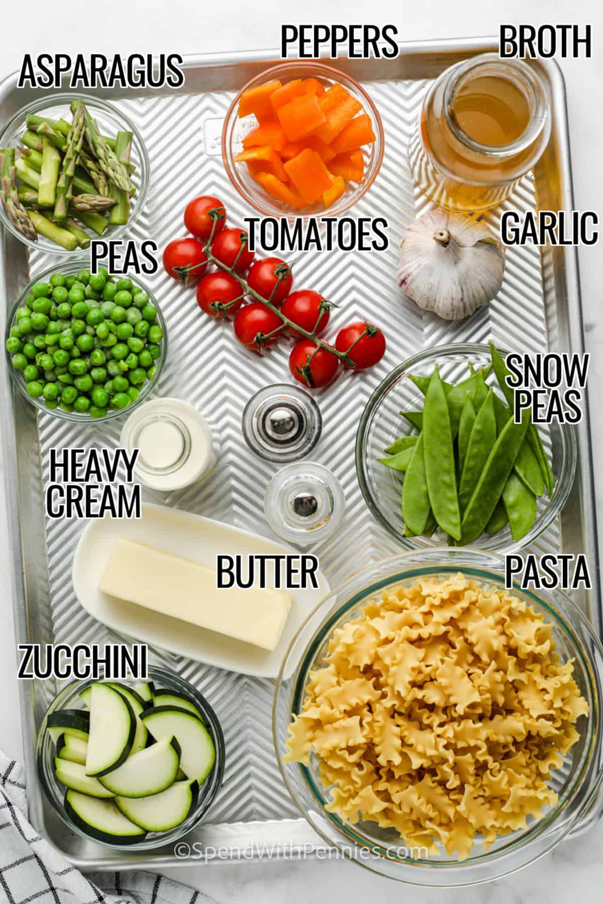asparagus , peppers , broth, tomatoes , garlic , snow peas, peas , pasta , heavy cream, butter and zucchini with labels to make Creamy Pasta Primavera