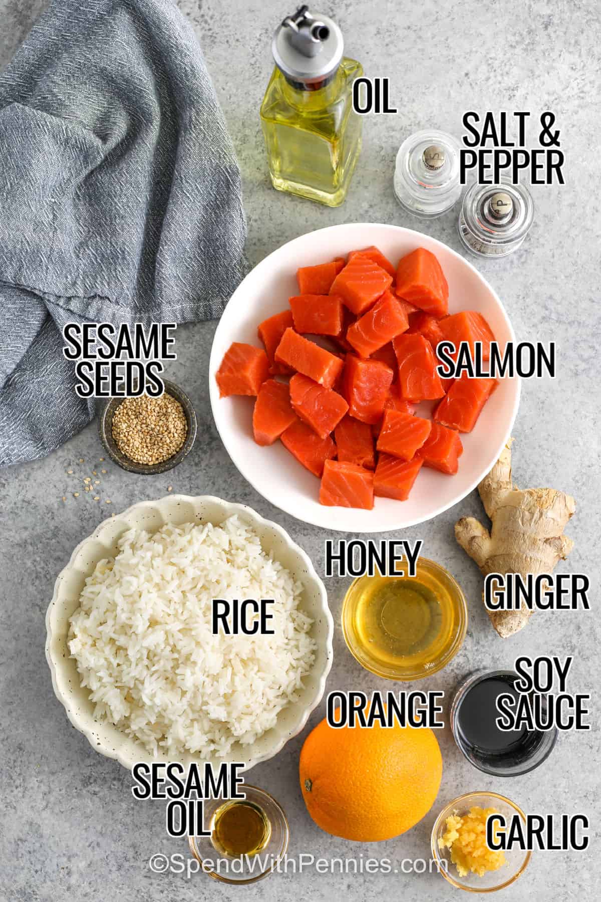 For a simple and flavorful meal, this salmon bowl recipe brings salmon, rice, and fresh toppings together. The salmon is cooked until tender, then coated in a sticky honey orange glaze with soy and sesame oil. Served over rice, it creates a satisfying meal that is both light and filling. Fresh vegetables add color, crunch, and balance to every bite. This easy salmon rice bowl recipe is perfect for everyday dinners or lunches. #spendwithpennies oil , salmon , sesame seeds , rice , sesame oil , orange , honey , garlic , soy sauce , ginger , salmon , salt and pepper with labels to make Salmon Bowl Recipe