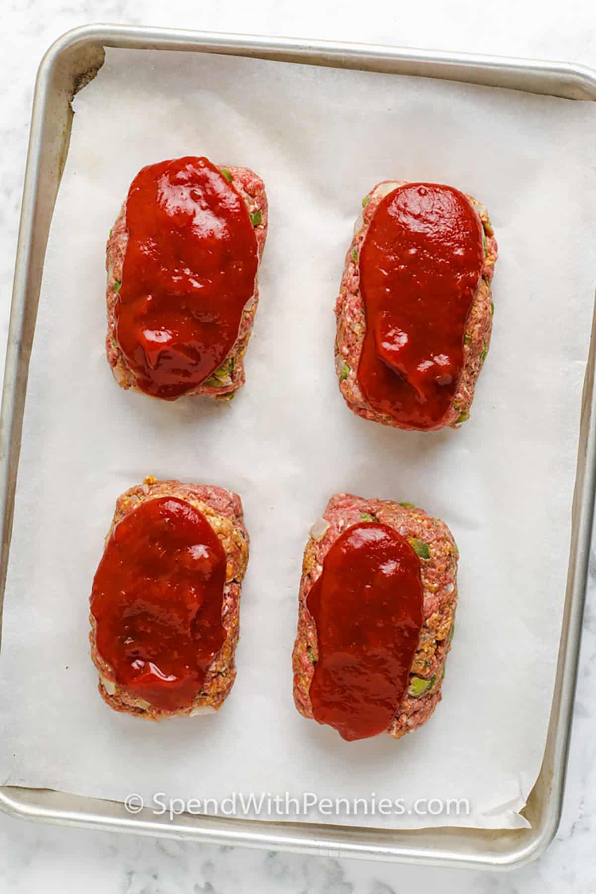 Šis mini kotleto receptas yra pagamintas iš paprastų ingredientų, tačiau vis tiek suteikia klasikinio mėsos pyrago skonio, prie kurio žmonės grįžta vėl ir vėl. Jautienos malta, troškintos daržovės, džiūvėsėliai ir truputis Dijono sukuria pikantišką pagrindą, o kečupo užpilas suteikia spalvos ir sklandaus, saldaus, aštraus skonio. Šis orkaitėje kepto mini kotleto receptas yra ypač patogus, kai norite patogiai valgyti mažesnėmis porcijomis ir greičiau iškepti. #išleisti su centais Mini Meatloaf Receptas ant skardos prieš gaminant