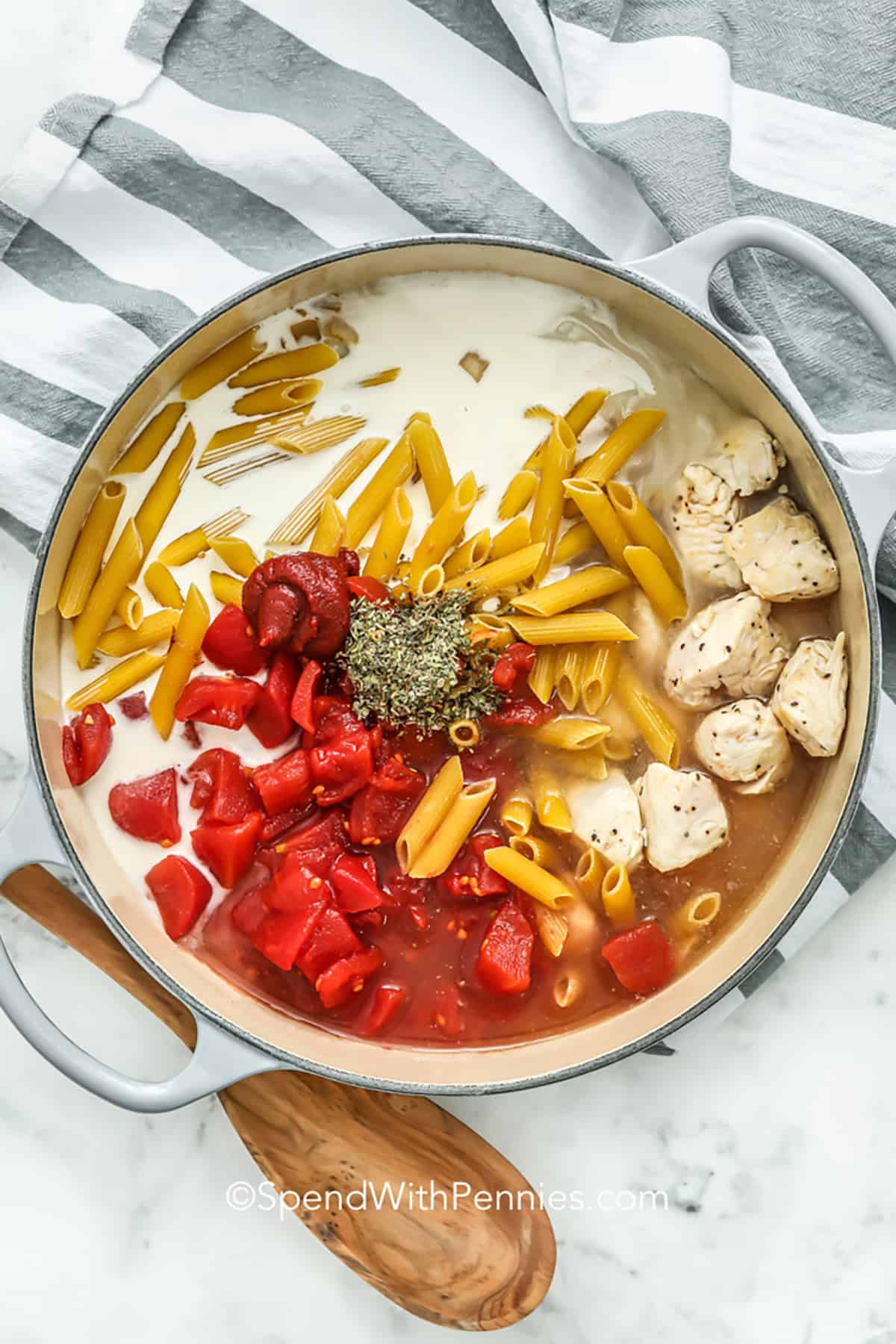 adding ingredients together in pot to make One Pot Chicken Pasta