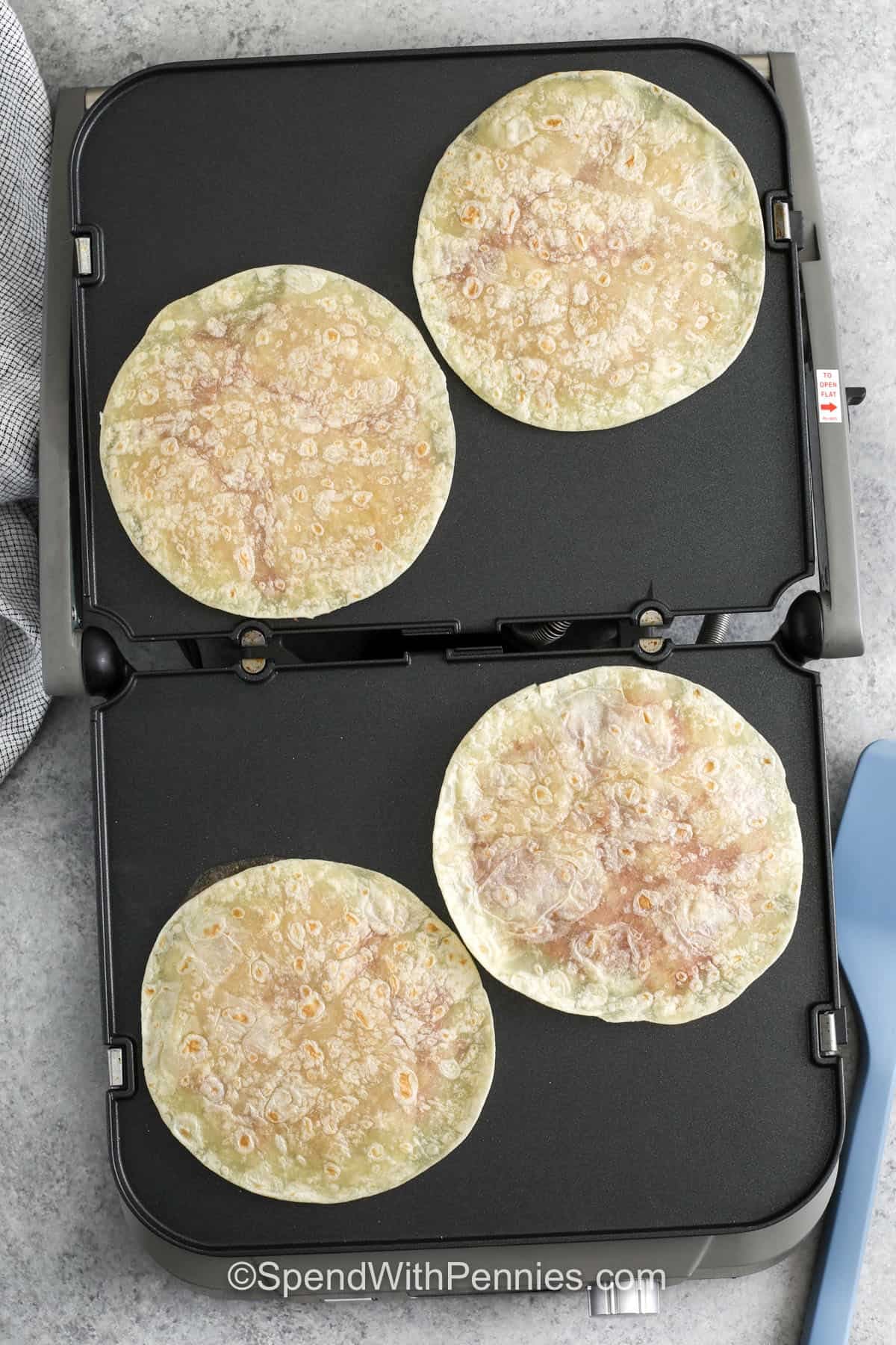 adding tortilla to cooker to make Smash Burger Tacos