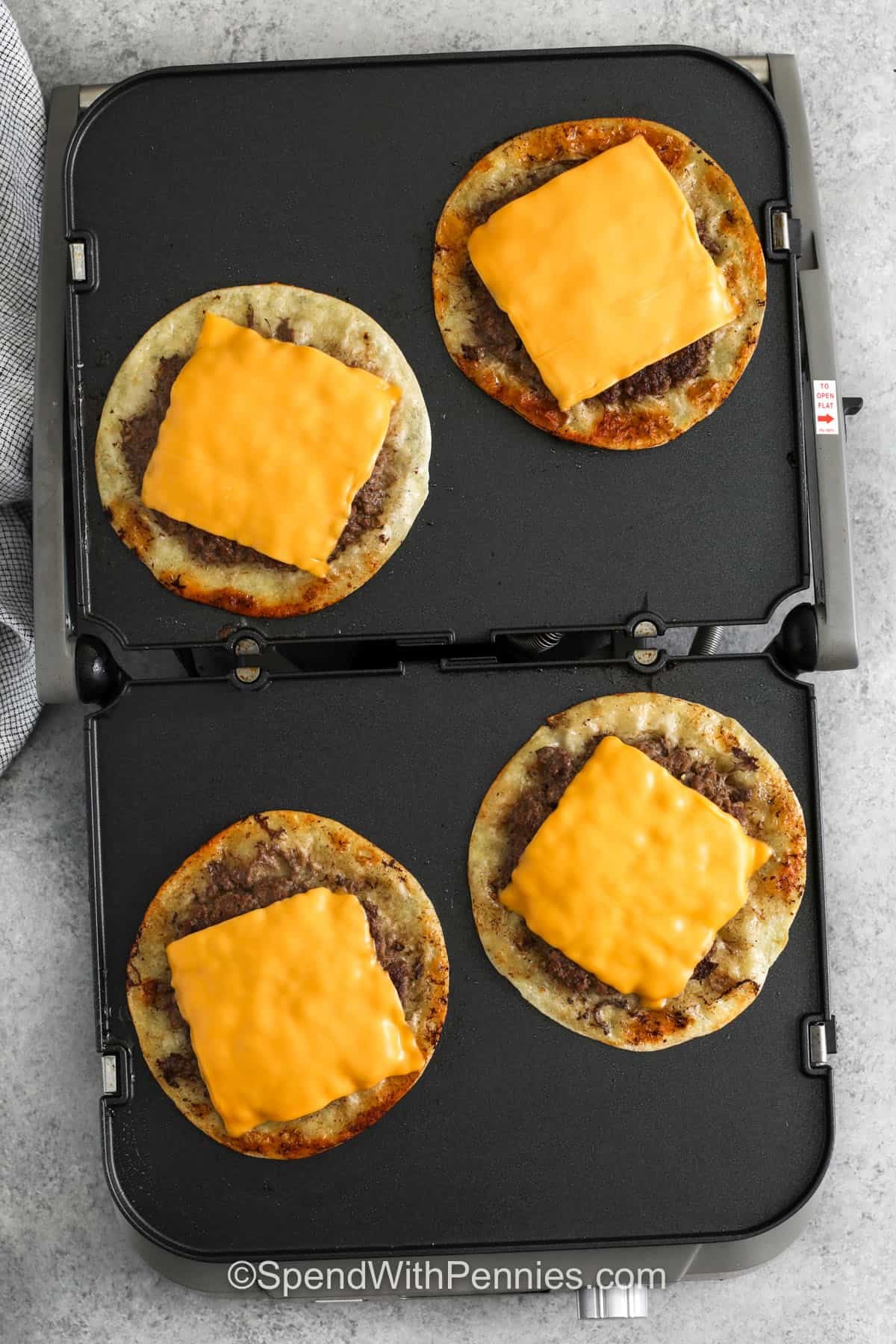adding cheese to Smash Burger Tacos