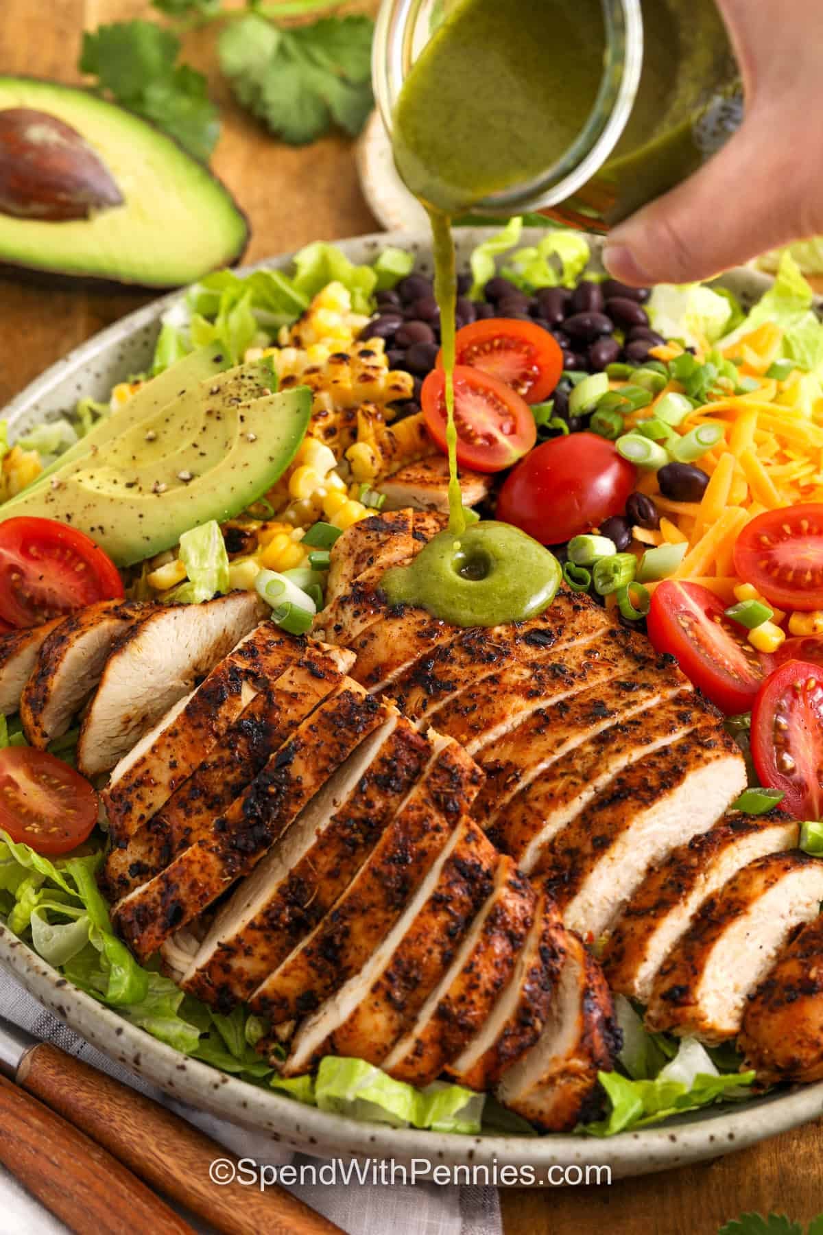 adding dressing over top Southwest Salad