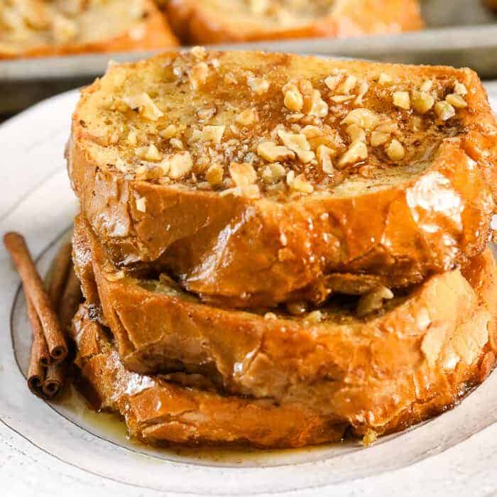 Overnight french toast on a plate with cinnamon sticks