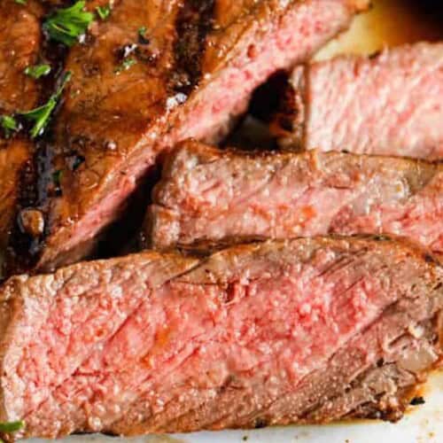 a close up of steak that has been marinating in steak marinade and then grilled