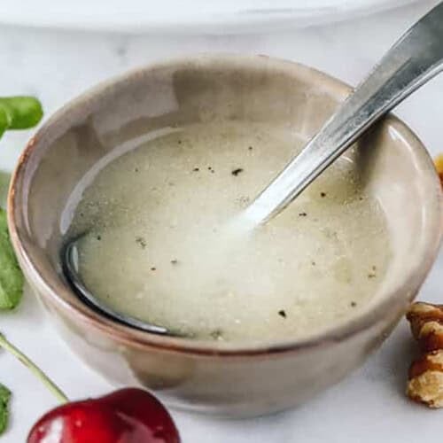 close up of Easy Arugula Salad Dressing in bowl
