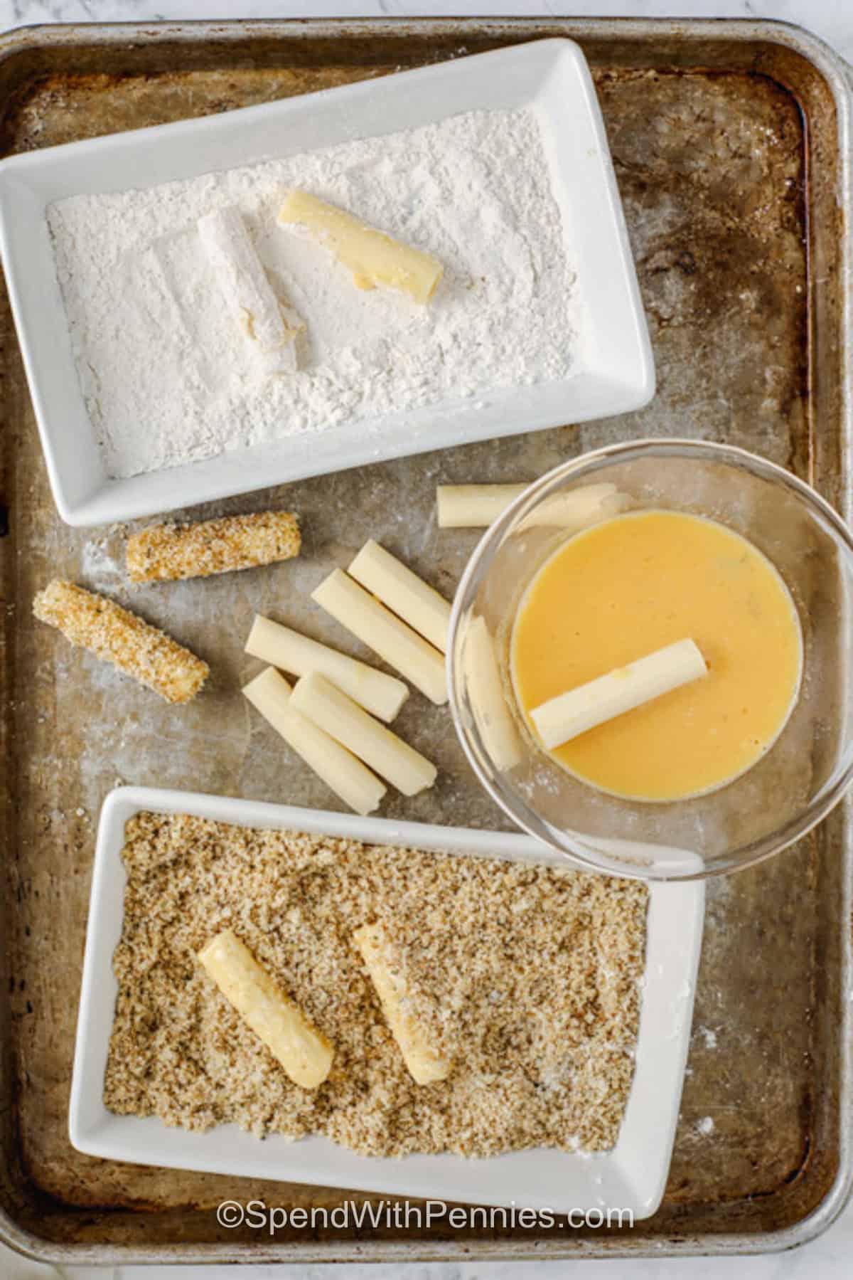 adding egg wash with flour and breadcrumbs to make Air Fryer Mozzarella Sticks