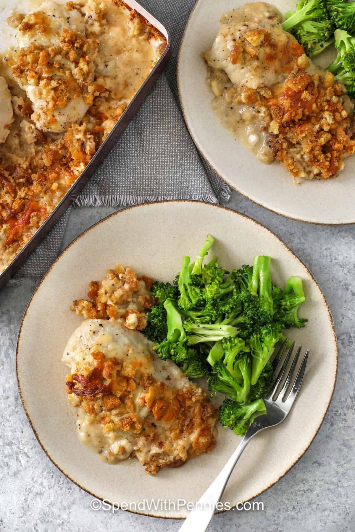 Caesar Chicken Recipe on plates with broccoli with casserole dish full