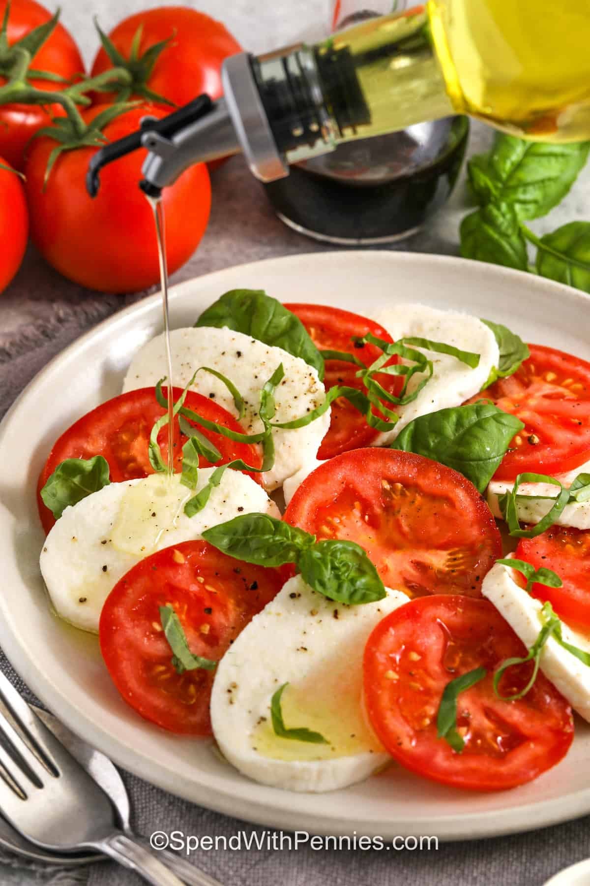 adding oil to Caprese Salad