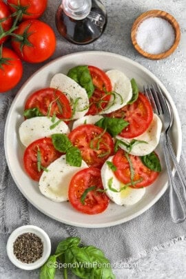 plate of Caprese Salad with a fork and spoon