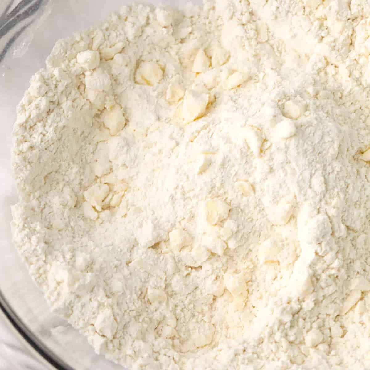 cutting butter into dry ingredients to make Homemade Biscuits