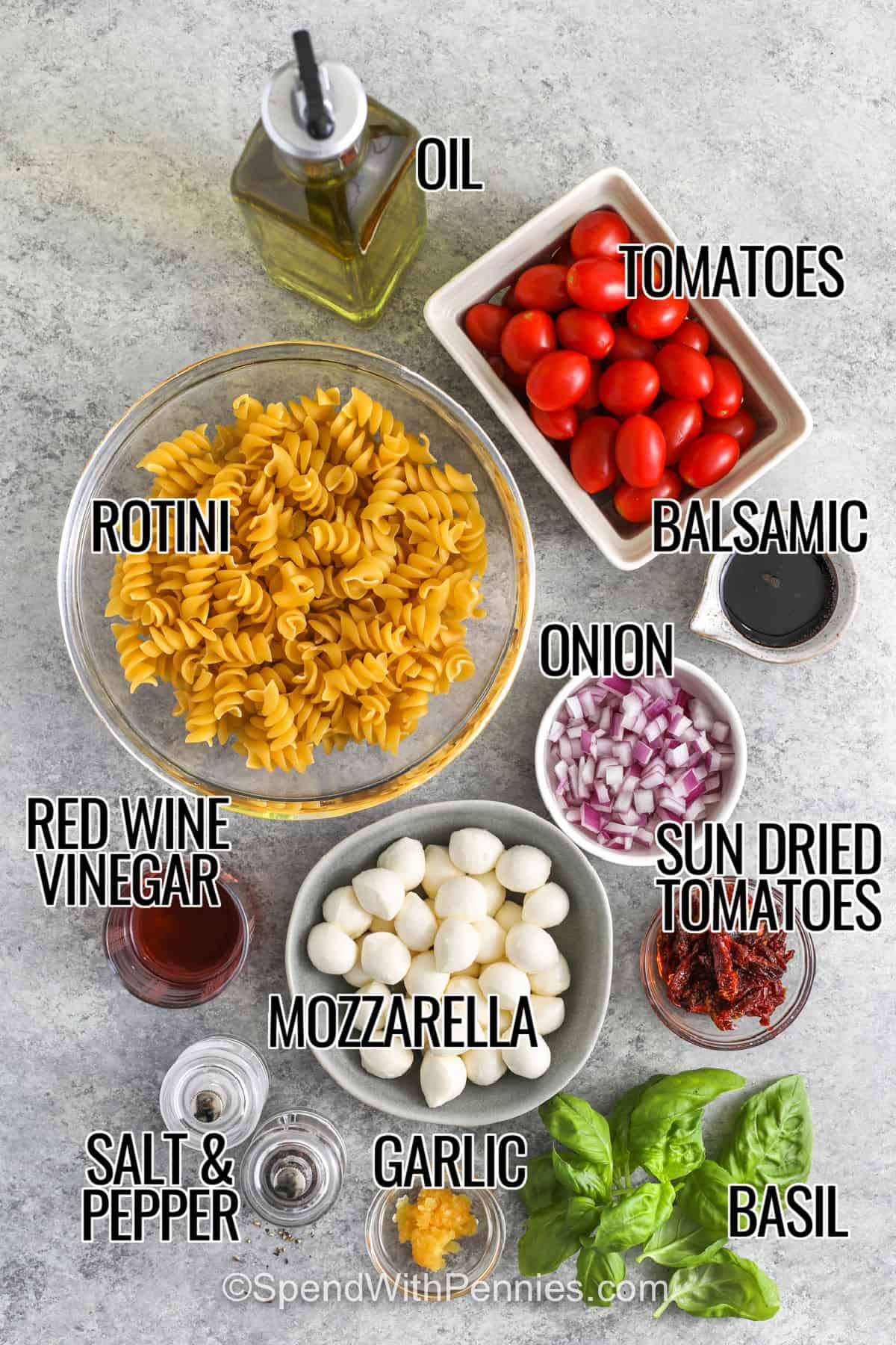 This easy Caprese pasta salad is packed with juicy tomatoes, creamy fresh mozzarella, fragrant basil, and tender pasta tossed in a simple homemade dressing. Sun-dried tomatoes add rich flavor while red onion gives every bite a little crunch. Serve this chilled pasta salad with grilled chicken, burgers, steak, or sandwiches for a fresh summer side that feels bright, simple, and satisfying. #spendwithpennies oil , tomatoes , balsamic , onion , sun dried tomatoes , basil , mozzarella , garlic , red wine vinegar , rotini , salt and pepper with labels to make Caprese Pasta Salad