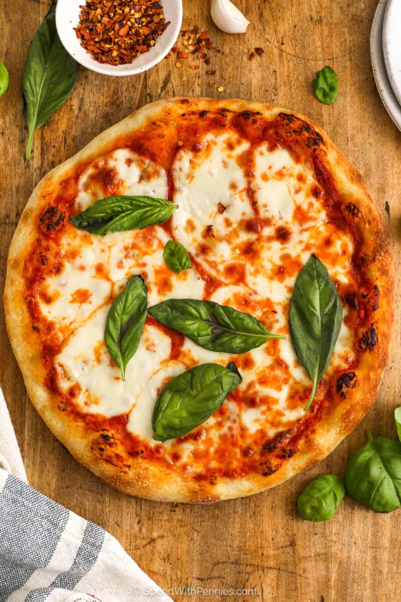 Whole Margherita pizza with fresh basil