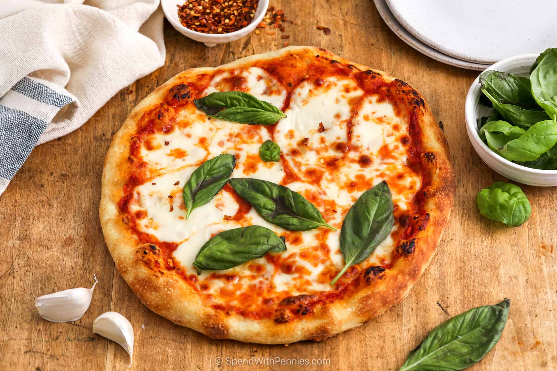 This fresh mozzarella pizza keeps things simple with just a few ingredients that work well together. The sauce is mixed with garlic for easy flavor, the dough can be homemade or store-bought, and basil adds a fresh finish. It is a margherita pizza recipe you can make again and again for both relaxed weekends and quick weeknight meals. #spendwithpennies Margherita pizza with fresh basil
