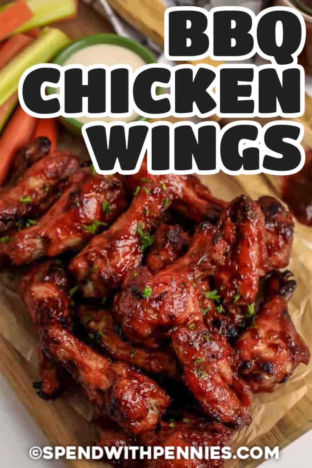 BBQ Chicken Wings on a wooden cutting board with celery and carrots and a title