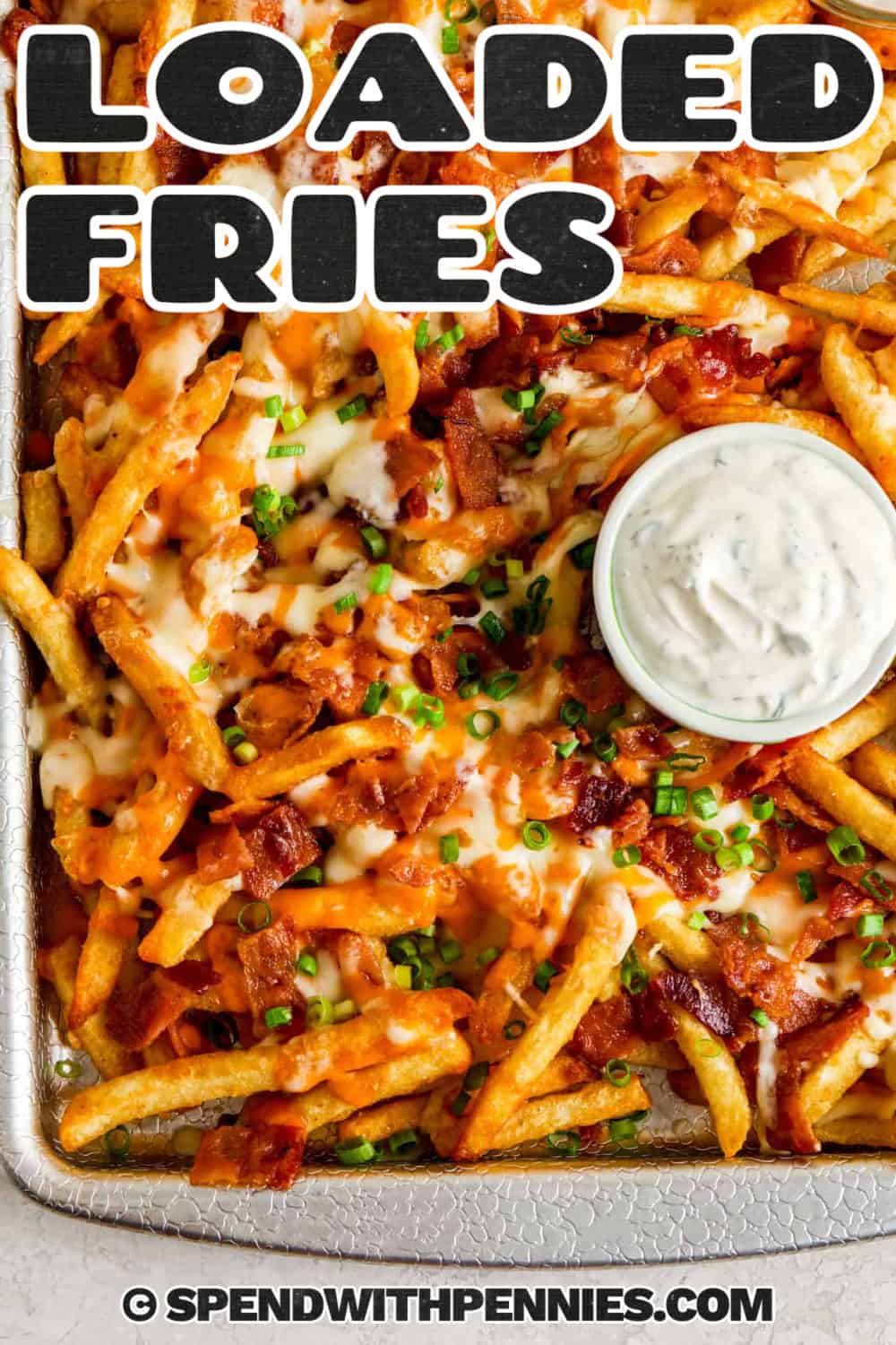 a pan of loaded fries with a side of sour cream with a title