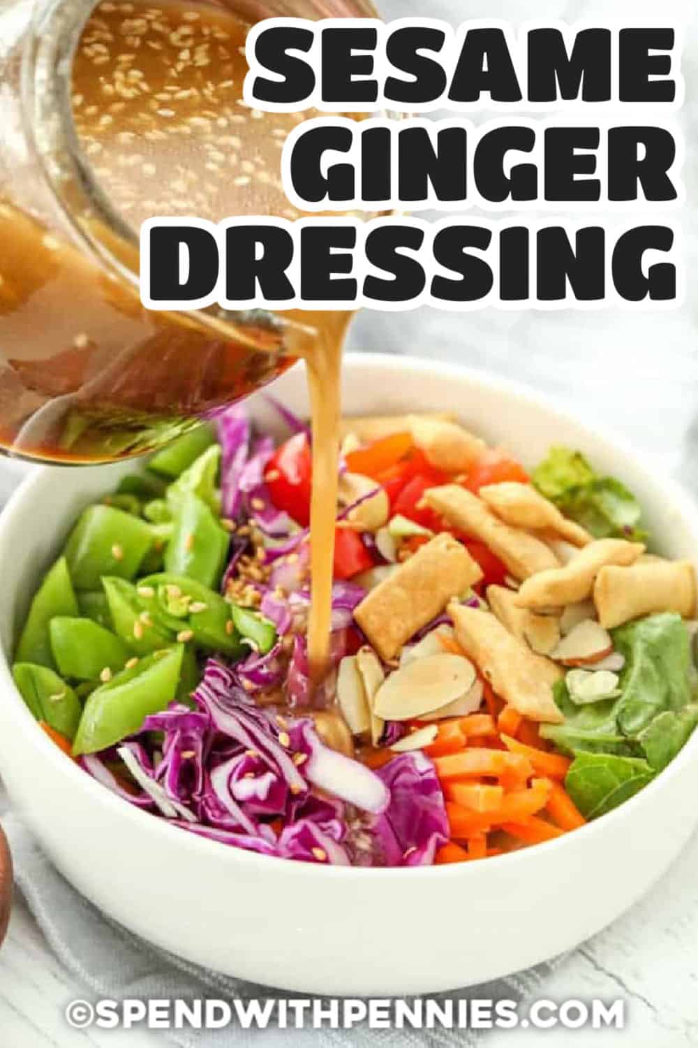 jar of Sesame Ginger Dressing being poured over a bowl of salad with title