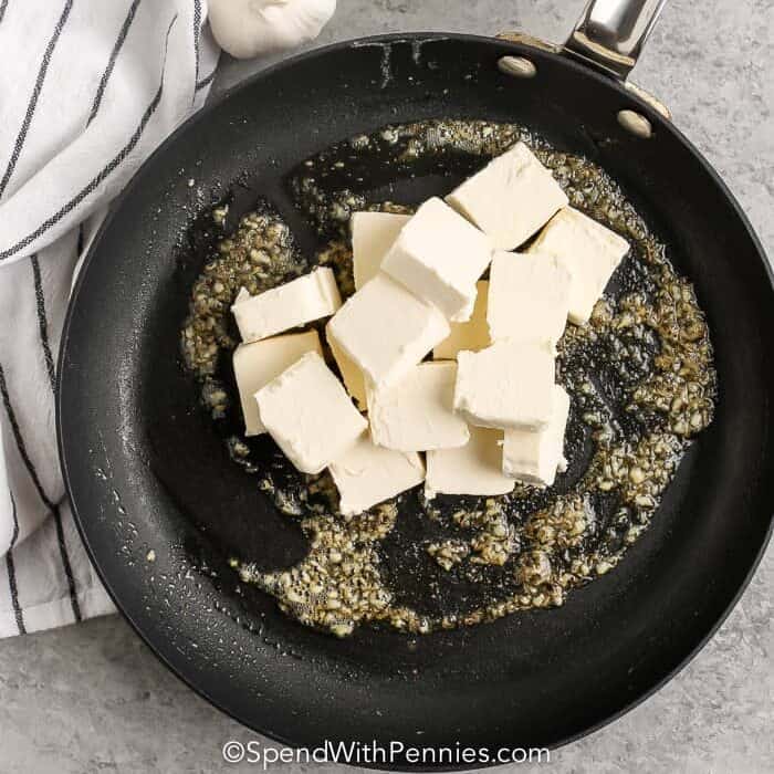 adding cream cheese to pan to make Cream Cheese Pasta Sauce