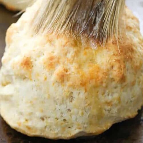 brushing butter over Homemade Biscuits
