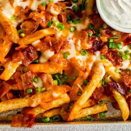 close up of Loaded Cheese Fries on a sheet pan