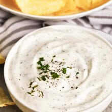 bowl of Sour Cream Dip with a bowl of chips in the background