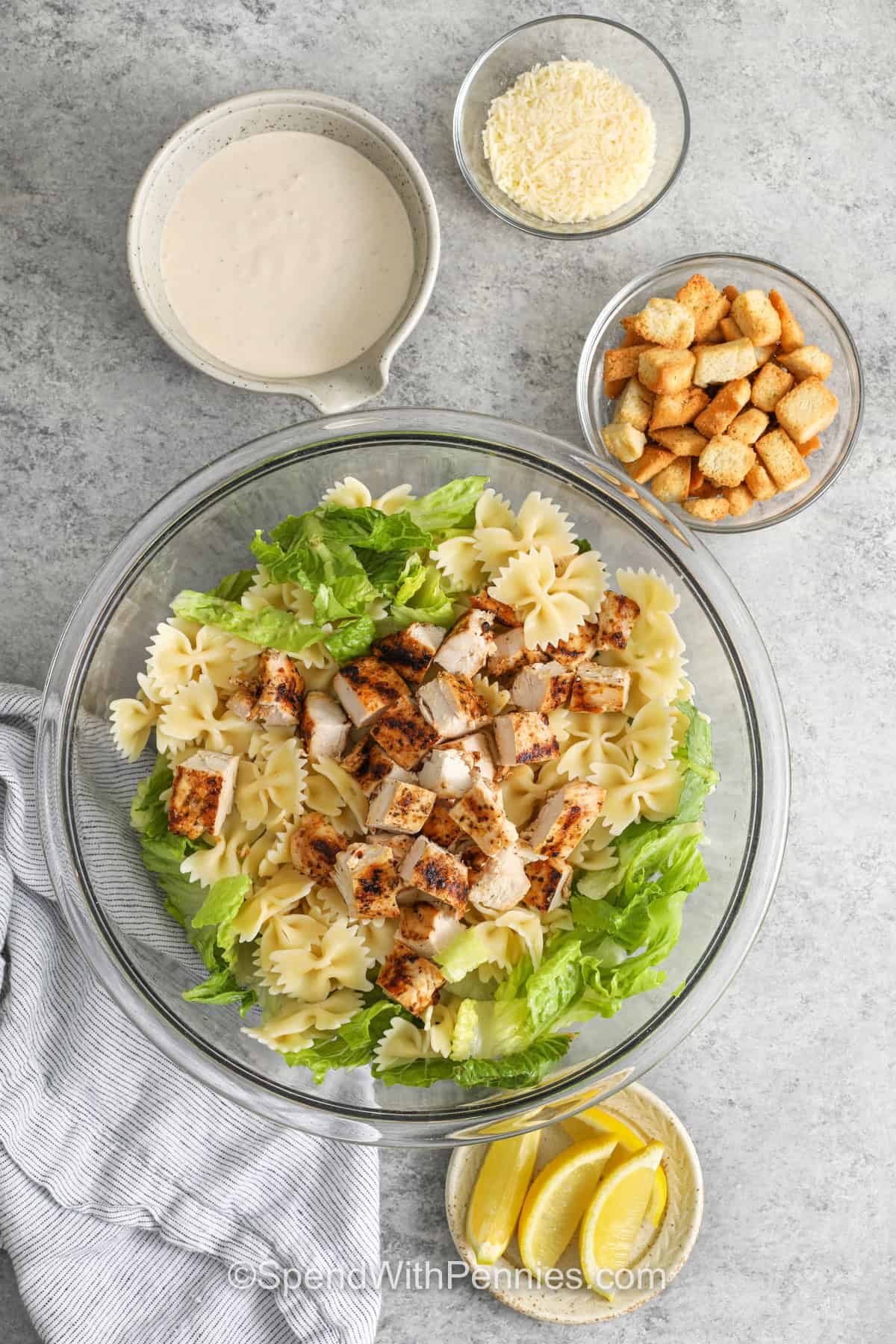 adding ingredients together for Chicken Caesar Pasta Salad
