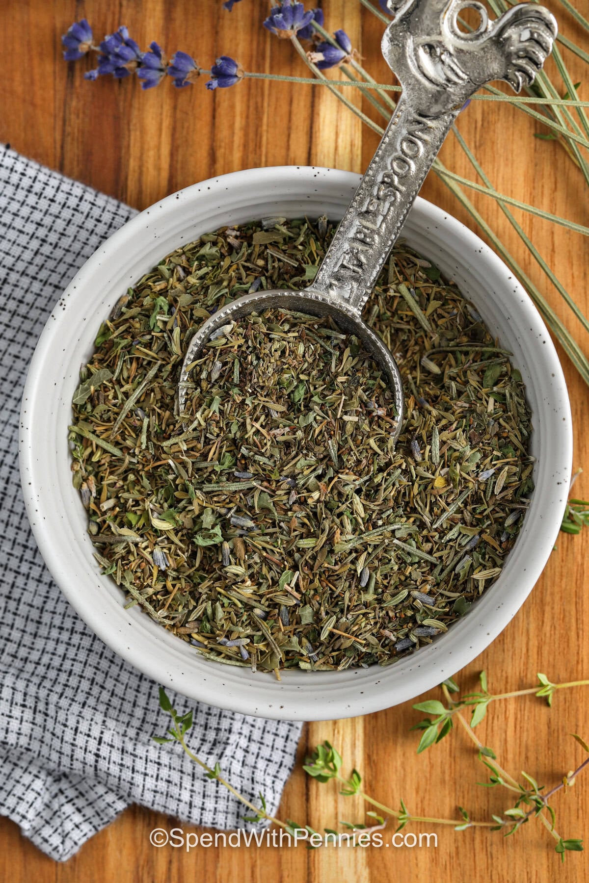 Herbes de Provence in a bowl with a measuring spoon