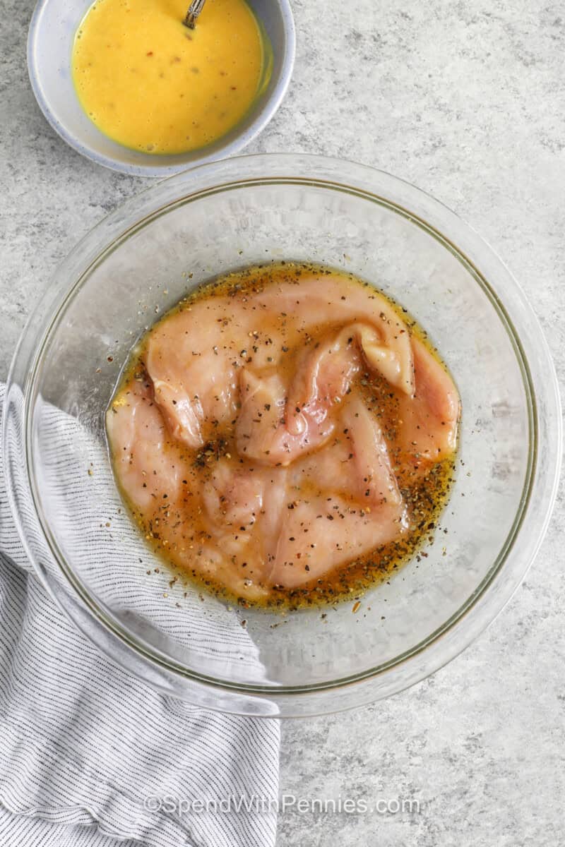 marinating chicken to make Hot Honey Chicken Sandwich