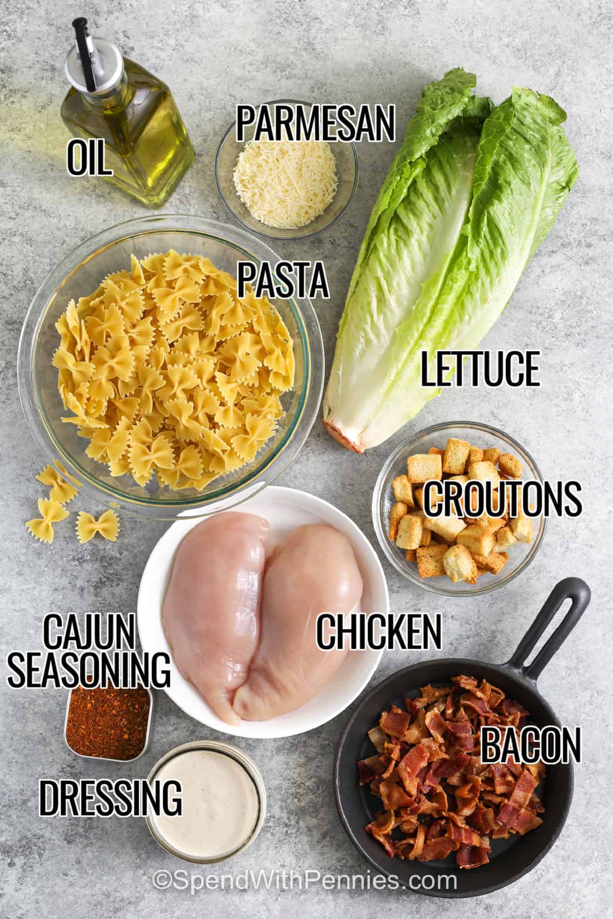 lettuce , parmesan , oil , pasta , croutons , chicken , cajun seasoning , bacon , dressing with labels to make Chicken Caesar Pasta Salad