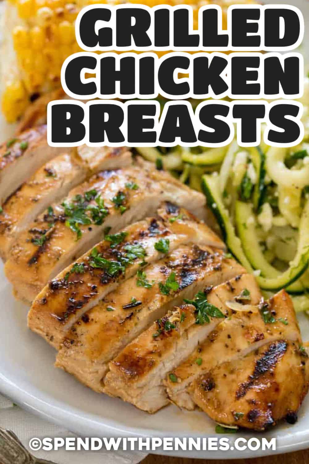 plated Grilled Chicken Breasts with zucchini noodles and corn with a title