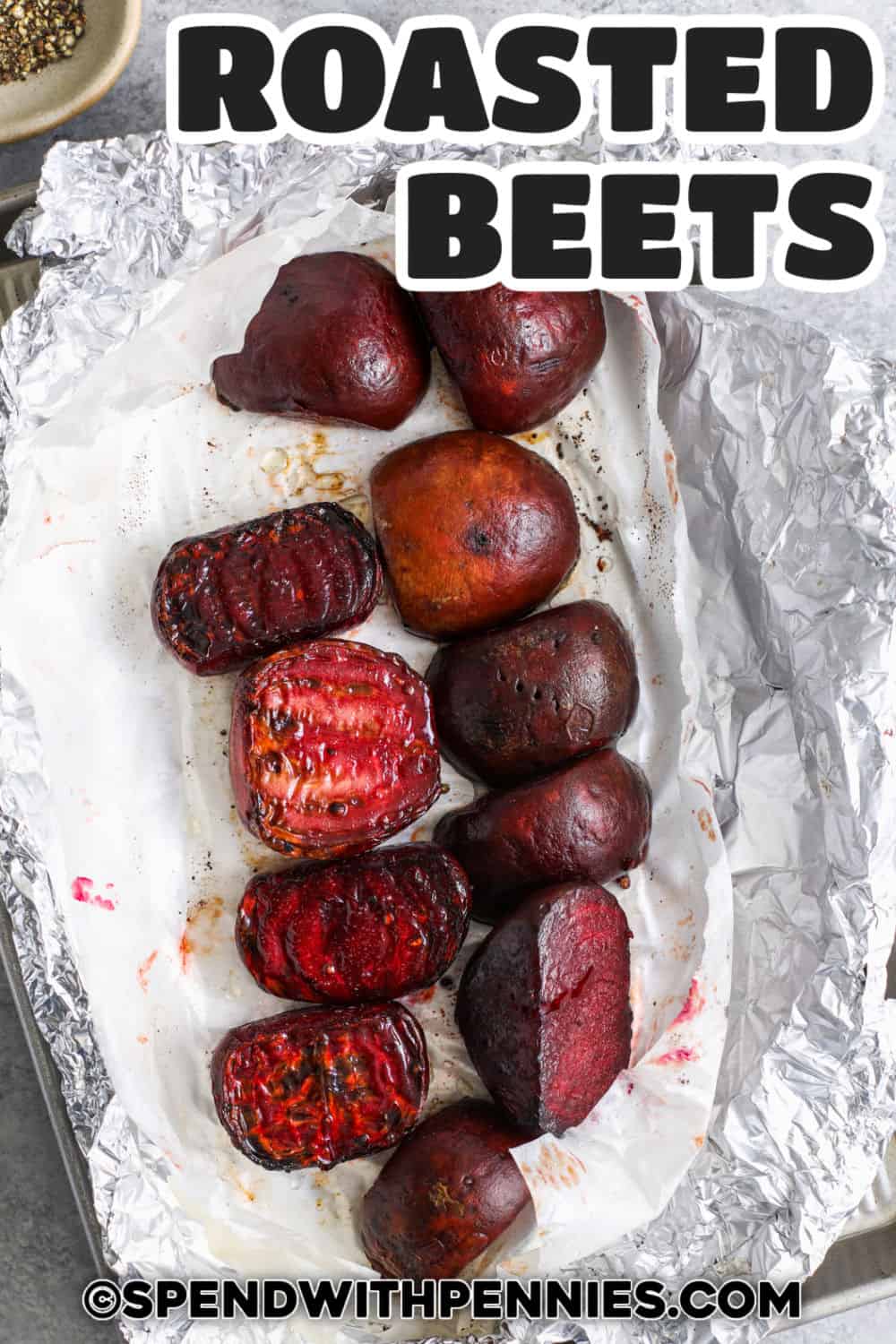 This easy recipe for roasted beets brings out their natural sweet and earthy flavor. Just scrub red or gold beets, trim them, and toss with oil and salt. Roast them in the oven until soft, and the skins peel off easily with just a little rubbing. Try them mixed with roasted carrot and potato for a colorful side dish. Or, top with creamy goat cheese and a drizzle of balsamic. These beets are also perfect in salads or soups! #spendwithpennies Roasted Beets on a sheet pan with a title