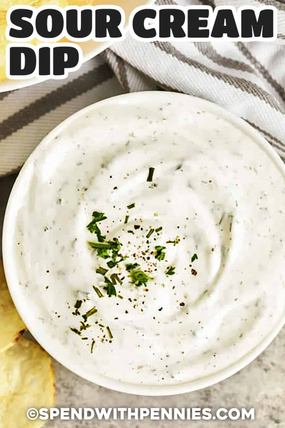 This sour cream dip recipe is a no-cook appetizer made with sour cream, mayonnaise, fresh chives, dried dill, and savory pantry seasonings. The short chill time helps the flavors blend and gives the dip a smooth, scoopable texture. It is perfect for veggie trays, chips, bagel chips, crackers, and snack boards when you need something easy, creamy, and crowd-friendly. Pin it for your next party. #spendwithpennies top view of Sour Cream Dip in a bowl with a title
