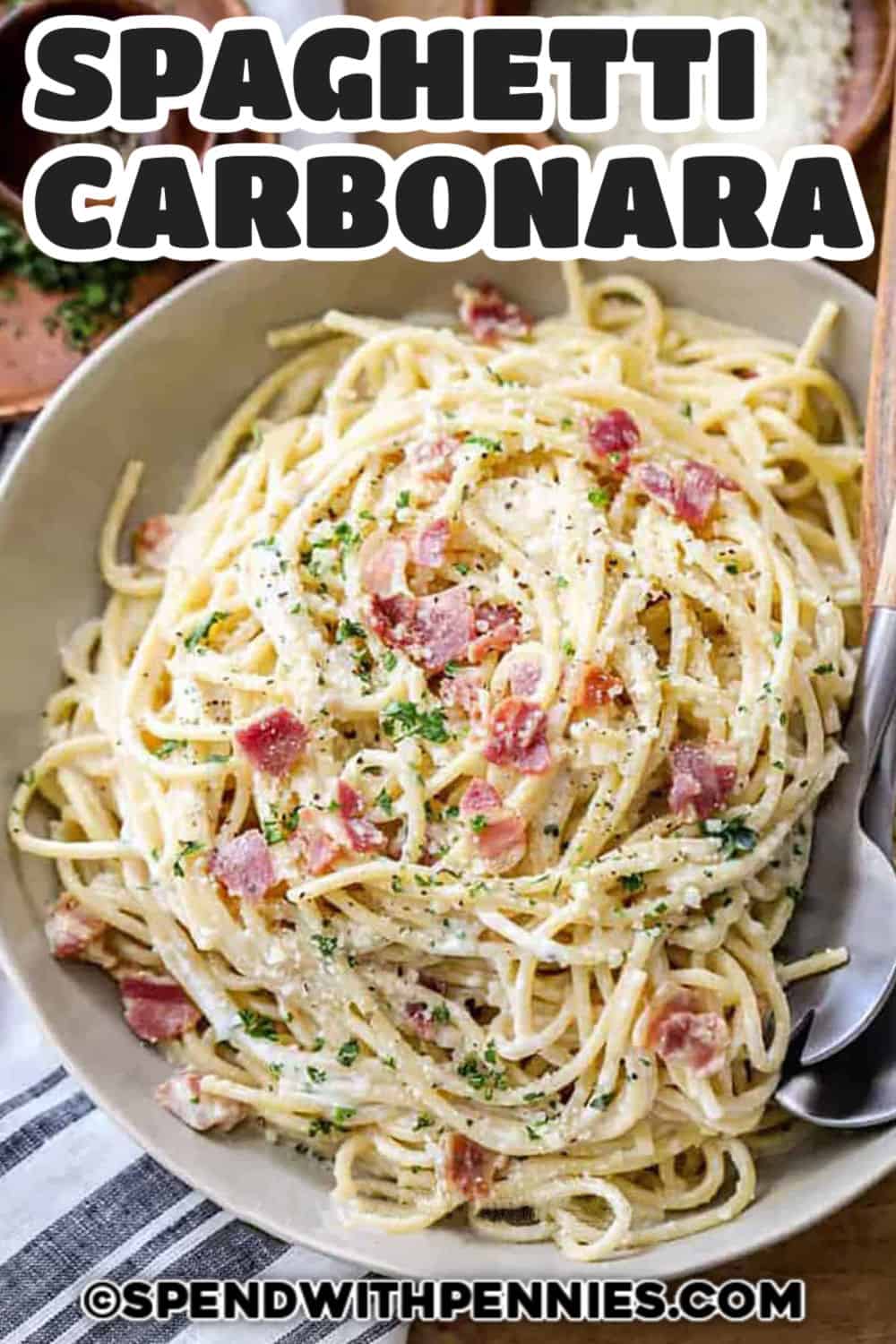 Spaghetti Carbonara topped with Parmesan and title