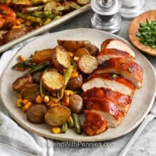 sliced Sheet Pan BBQ Chicken with potatoes corn and green beans