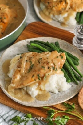 Smothered Chicken on mashed potatoes and green beans