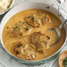 Smothered Chicken in the pot with a spoon