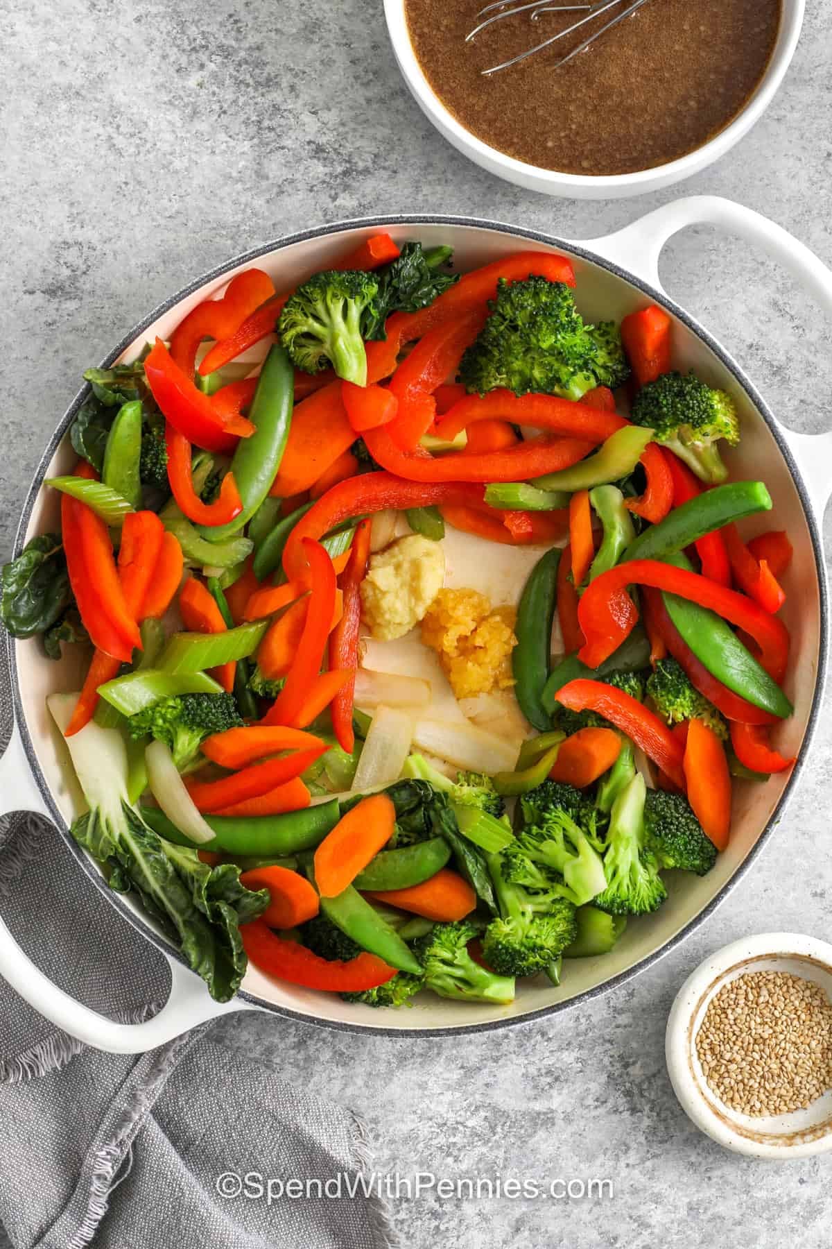 adding garlic and ginger paste to vegetables in pot to make Stir Fry Vegetables
