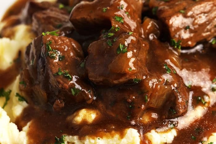 close up of Beef Tips on potatoes