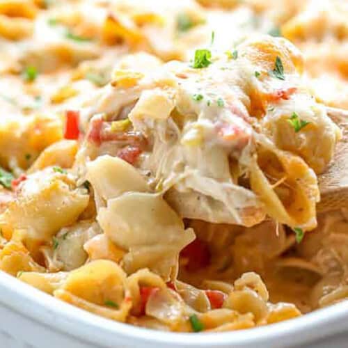 taking a spoonful of Cheesy Chicken Casserole out of dish