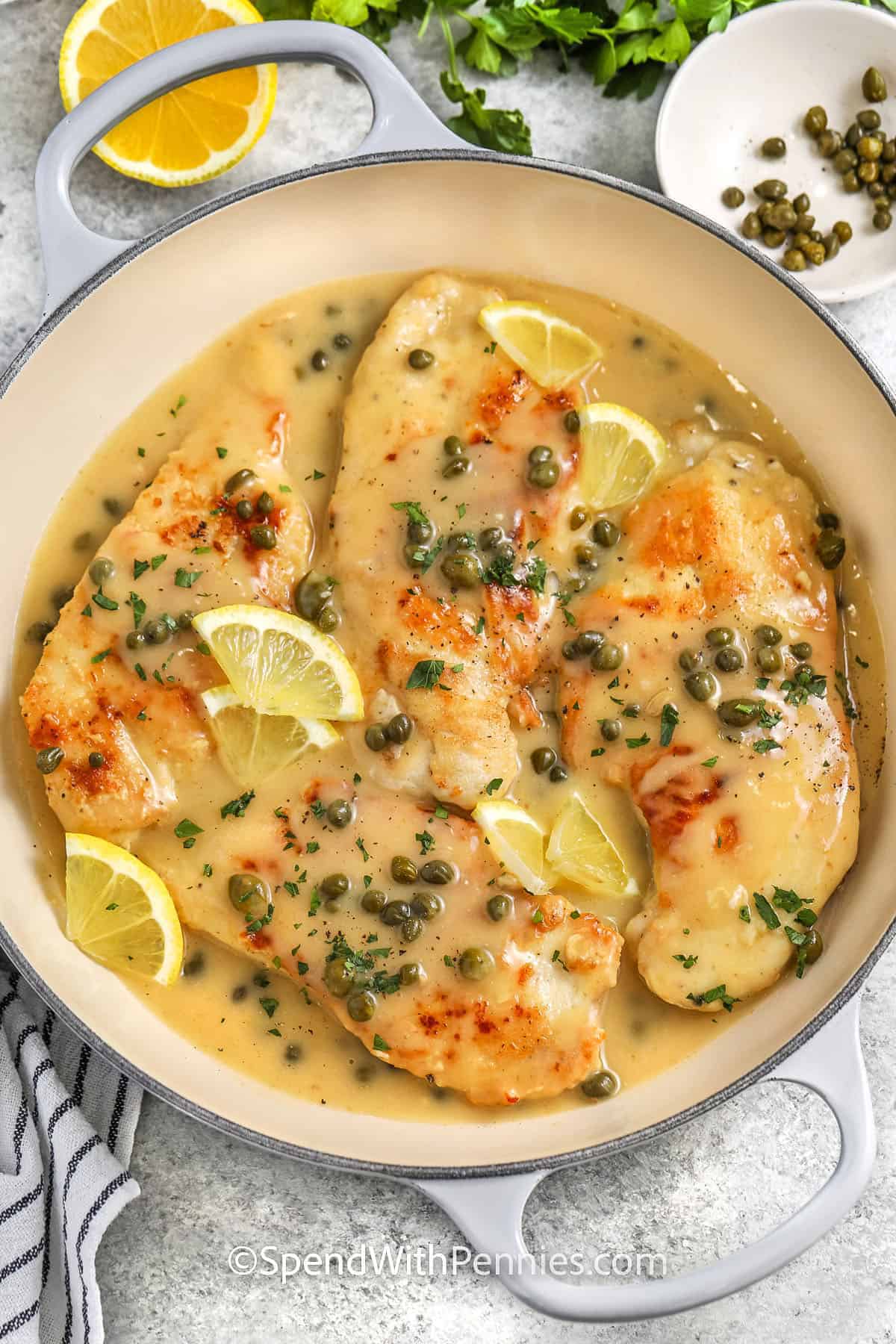 Classic chicken piccata is a flexible dinner made with tender chicken breasts and a glossy lemon butter pan sauce. The chicken is pounded evenly for fast cooking, lightly floured for golden edges, and simmered briefly with white wine, broth, and drained capers. Use extra broth instead of wine when needed, and finish with parsley or optional Parmesan. Leftovers reheat well over low heat with a splash of broth for an easy next-day lunch. #spendwithpennies chicken piccata in a skillet
