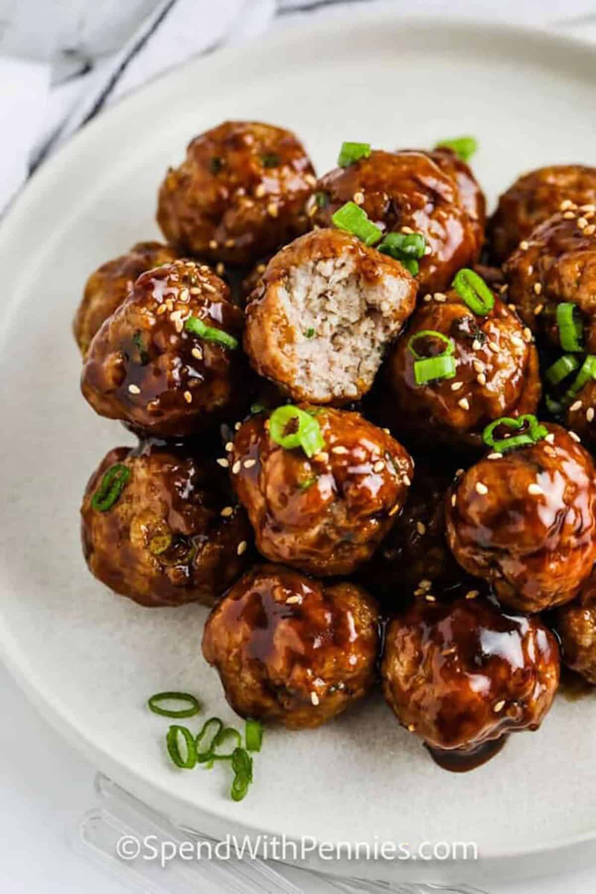 These hoisin meatballs are made with ground pork, panko bread crumbs, fresh ginger, and toasted sesame oil for a tender texture and bold flavor. A quick hoisin glaze makes them sticky, shiny, and delicious. They work as an appetizer, meal prep protein, or easy dinner served over jasmine rice with crisp vegetables. Save this meatball recipe for dinner tonight. #spendwithpennies hoisin glazed meatballs