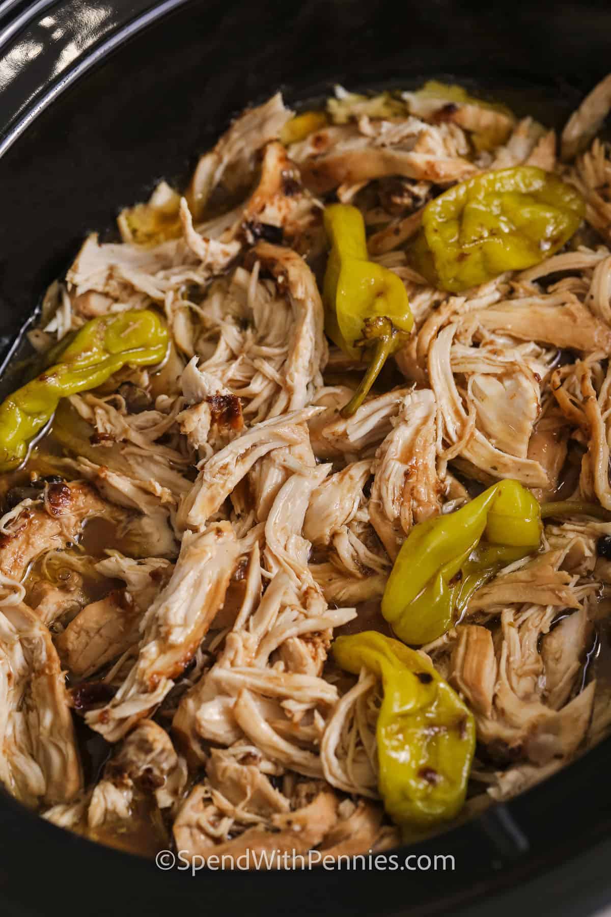 Crock Pot Mississippi chicken is a flavorful shredded chicken recipe with a buttery, tangy sauce made right in the slow cooker. The combination of pepperoncini peppers, ranch seasoning, and au jus gravy mix gives plain chicken breasts a rich Southern-inspired flavor. It is delicious served over noodles, spooned onto baked potatoes, or piled high on toasted buns. #spendwithpennies Mississippi Chicken in the crock pot