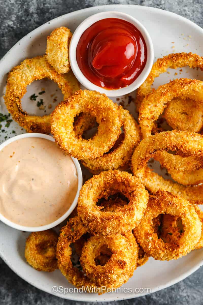 top view of Air Fryer Onion Rings with dip and ketchup on the side