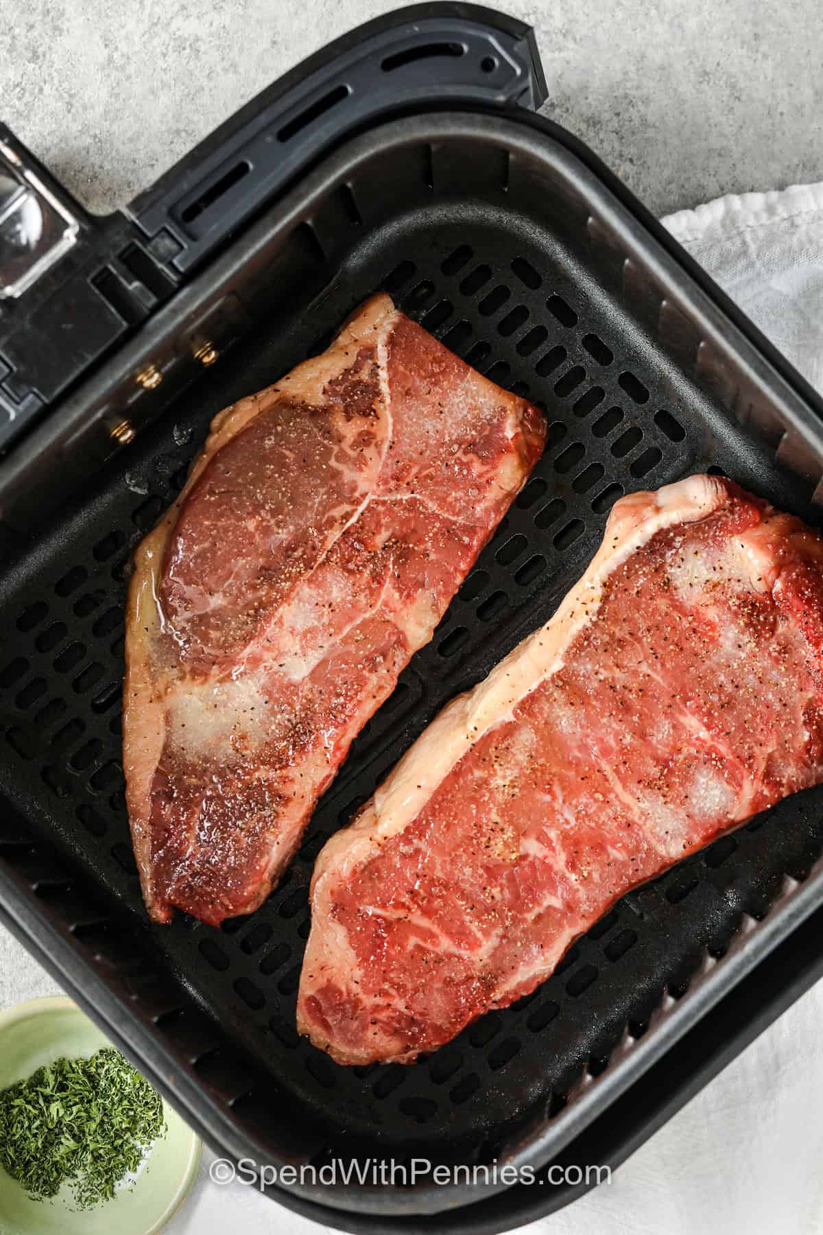 adding steaks to air fryer to make Air Fryer Steak